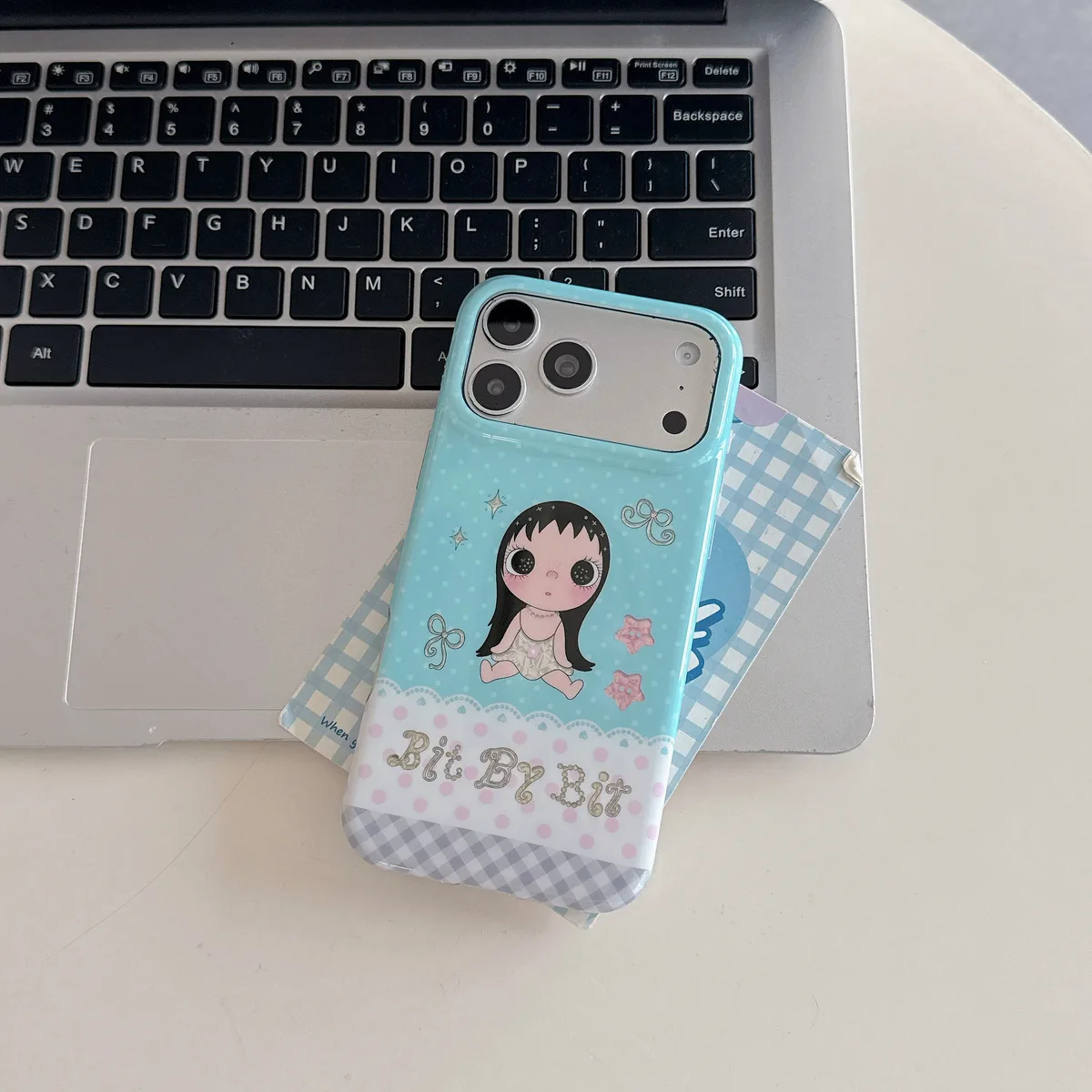 Kawaii Bit By Bit phone case with cute doll print and pastel blue design for iPhone 17 16 15 Pro Max