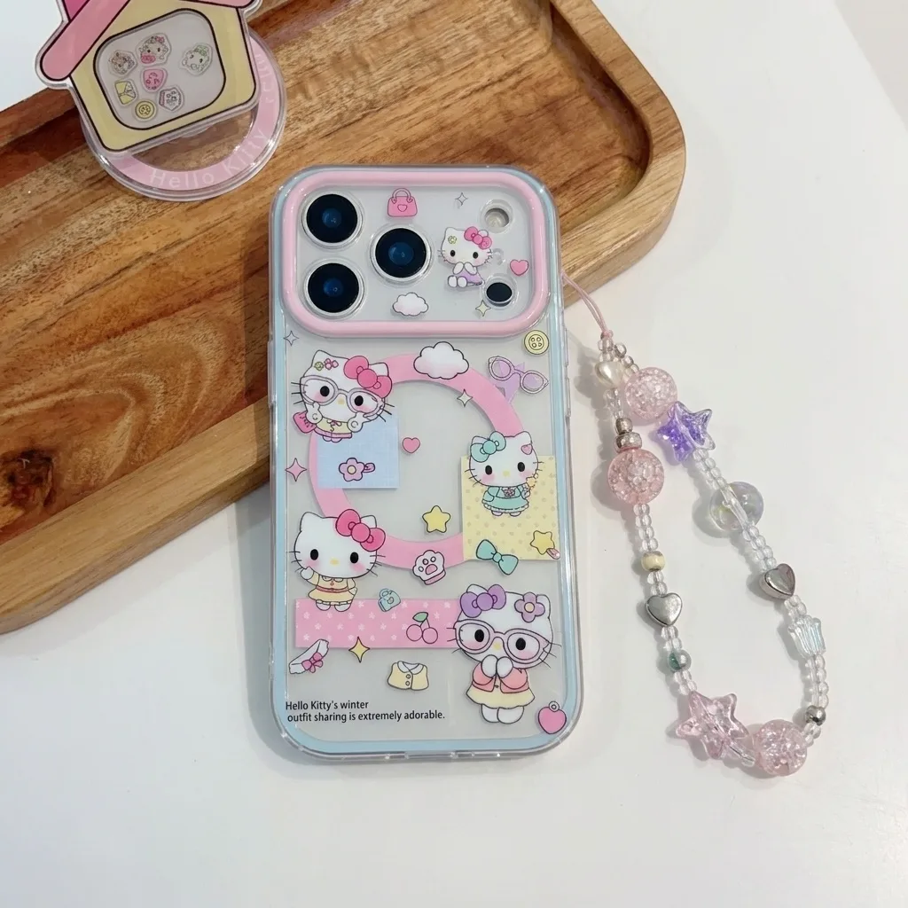 A clear phone case with Hello Kitty designs and a pink magnetic stand, shown on a wooden tray with a beaded strap.