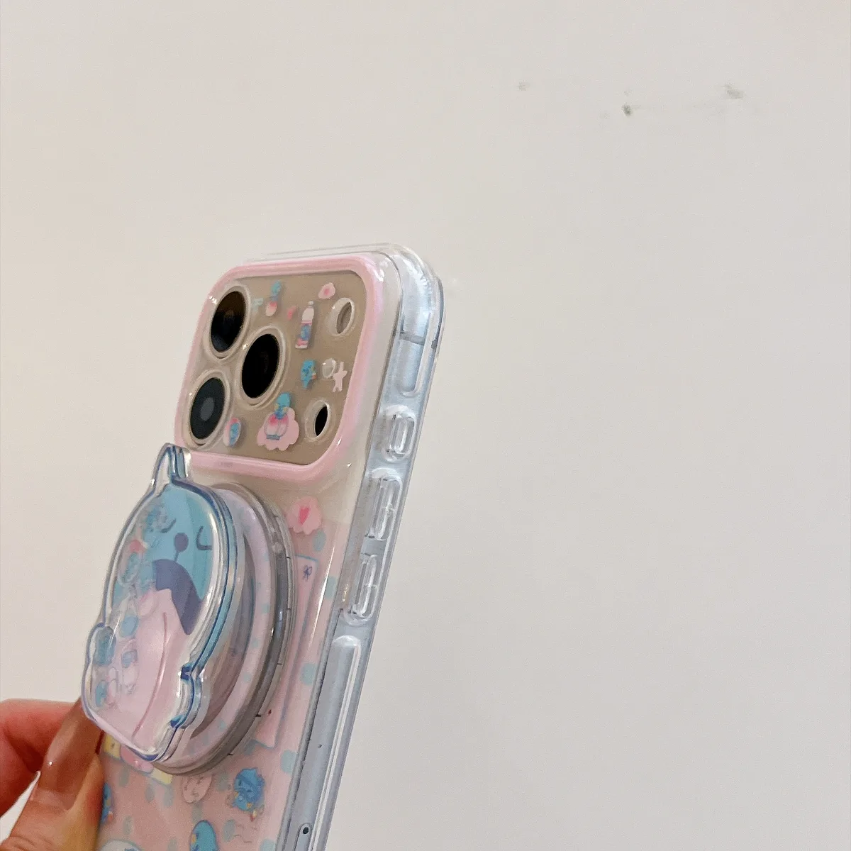 Cute blue bear clear phone case with beaded charm and pop-out grip for iPhone 17 16 15 Pro Max — MagSafe