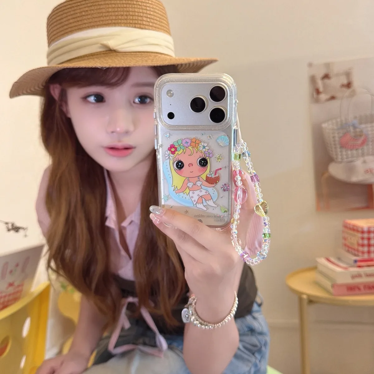 Clear phone case with a cartoon flower girl design and a colorful beaded wrist strap