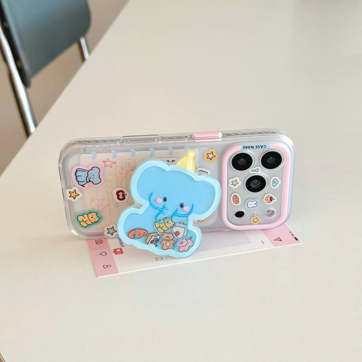 Clear pastel phone case with blue elephant charm and beaded wrist strap for iPhone 17 16 15 Pro Max
