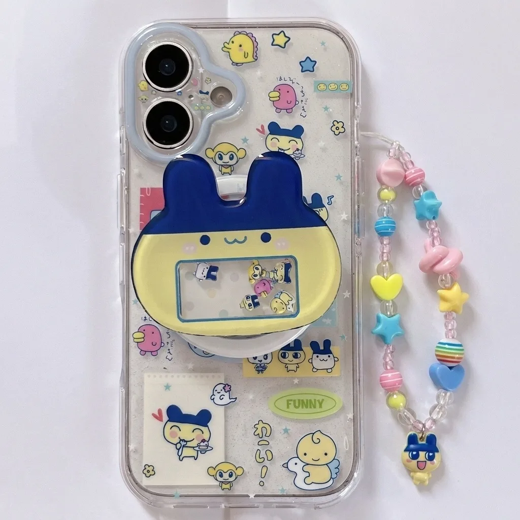 Clear phone case with Tamagotchi characters and a pop-up stand, shown with a beaded strap.