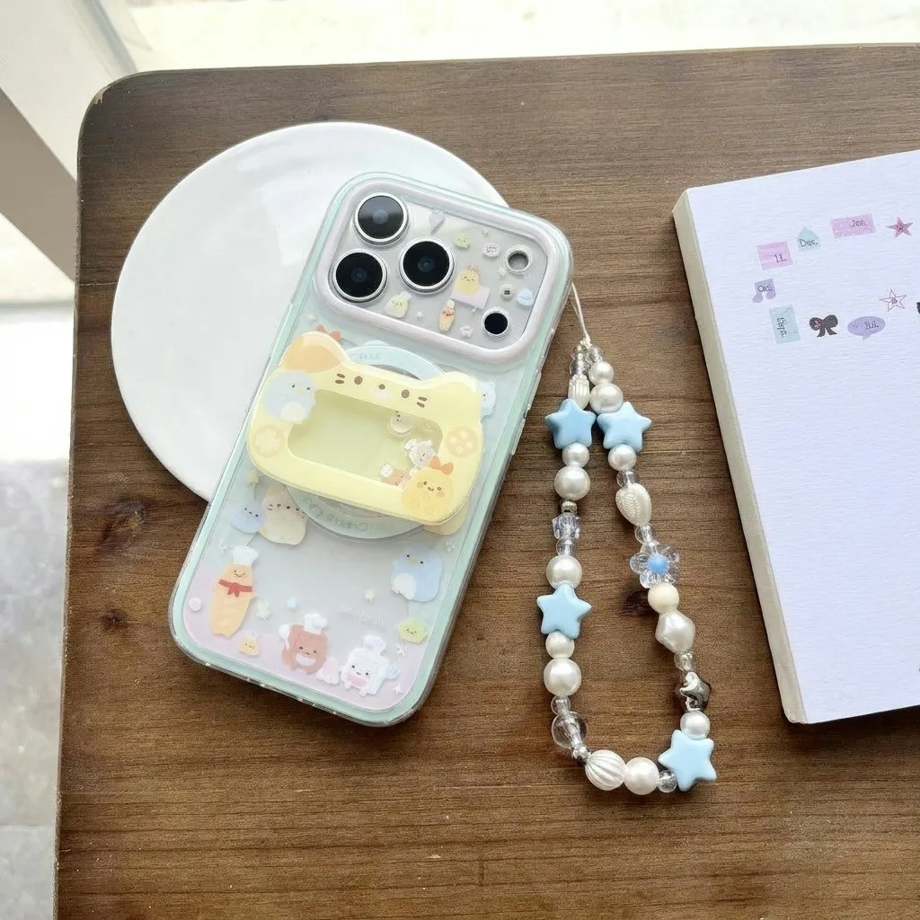 Clear pastel phone case with cute cartoon decorations and a beaded wrist strap
